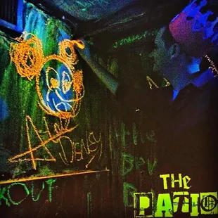 The black lit chalk room located next to the back bar at The Patio