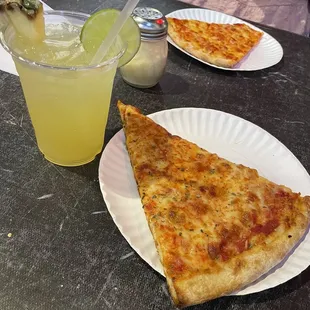 Pizza slice and a margarita
