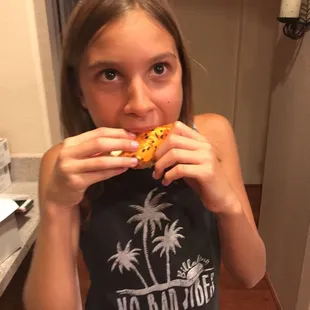 a girl eating a donut