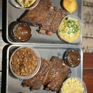 Rib dinners. One with Loaded Mashed Potatoes and  (Mexican Street Corn) the other with baked beans and Mac-n-Cheese.