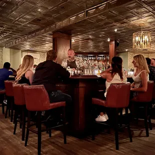 a group of people sitting at a bar
