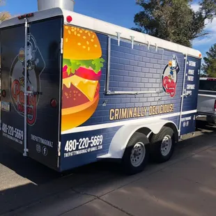 a large hamburger on the side of the truck
