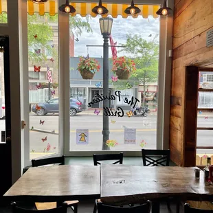a table and chairs in front of a window