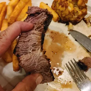 This is a 31$ "Filet Mignon" ordered to be cooked "medium"....looks like a well done bottom round roast