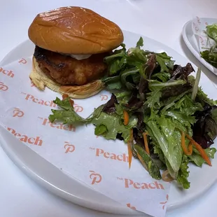 Smashed fried chicken, Thai chili,  honey aioli on potato roll.