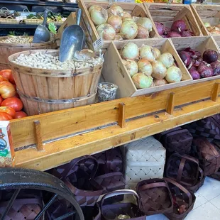 A cart of tomatoes, peanuts, and onions