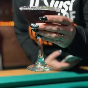 a woman holding a cocktail glass