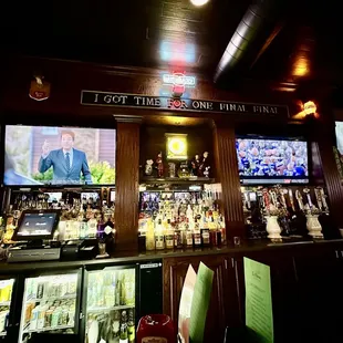 a bar with several televisions on the wall