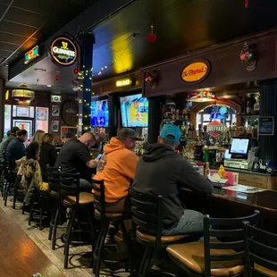 several people sitting at a bar