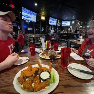 a man and woman sitting at a restaurant table