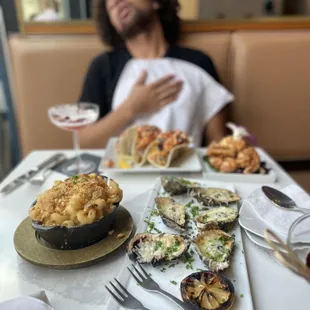 a man sitting at a table with food