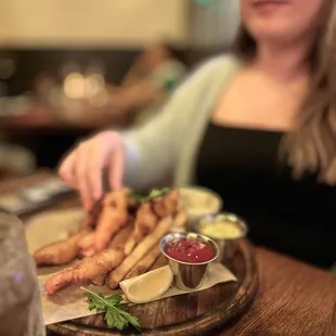 a woman sitting at a table with a plate of food