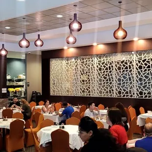 a large group of people sitting at tables in a restaurant