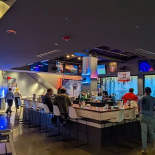 a large group of people sitting at a bar