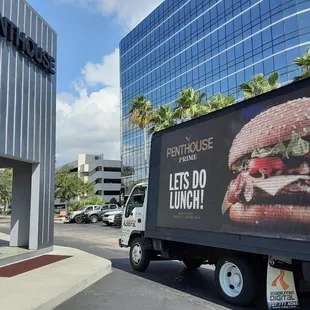 a delivery truck parked in front of the hotel