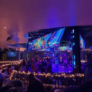 a stage with people sitting at tables