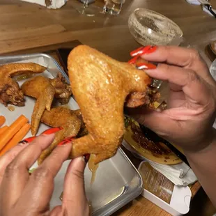 a person eating a chicken and carrots