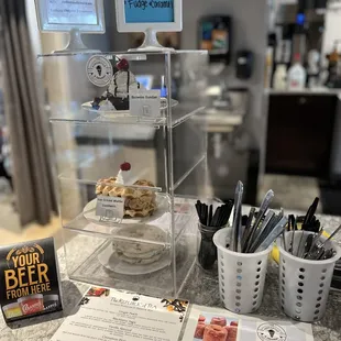 a counter with a menu and a sign