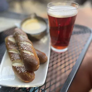a plate of pretzels and a glass of beer