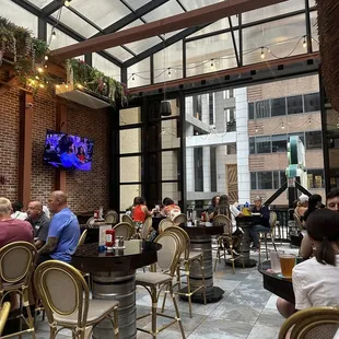 people sitting at tables in a restaurant