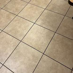 a tile floor with a bench