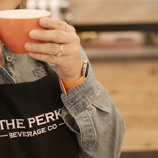 a woman holding a cup