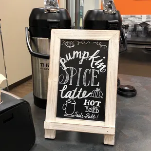 a chalkboard sign for a coffee shop