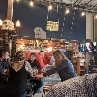 a group of people sitting at a bar