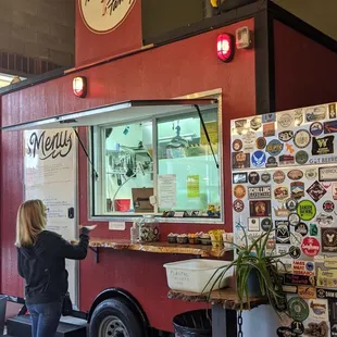 a woman ordering food from a food truck