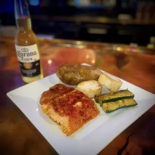 a plate of food and a bottle of beer