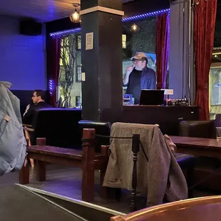 a man sitting at a table with a laptop