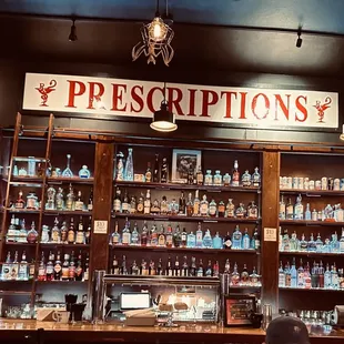 a bar with a variety of bottles on the shelves