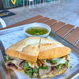 Pho dip sandwich with brisket and side of broth for dipping