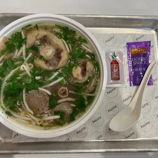 Dine-in. Pho dac biet $13, oxtail add-on $4. Very little basil . Need a small bowl to mix sauce for dipping.