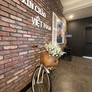 a bicycle parked against a brick wall
