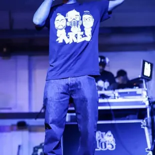 a man on stage with a camera