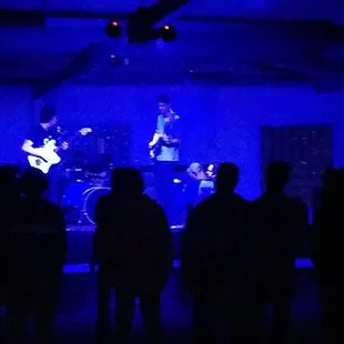 a band performing in a dark room