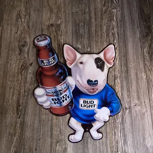 a dog in a blue shirt with a bottle of bud light