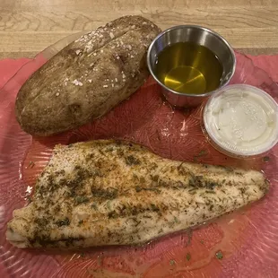 a plate of fish, bread and dipping sauce