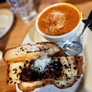 a bowl of soup and a grilled cheese sandwich