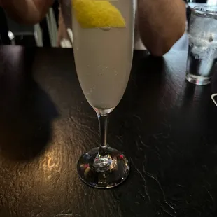 a man sitting at a table with a drink