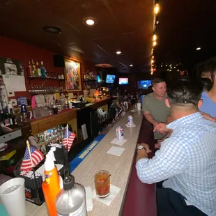 a group of people sitting at a bar