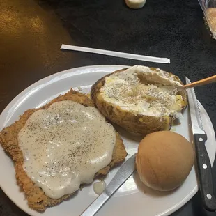 Chicken fried steak with baked potato.