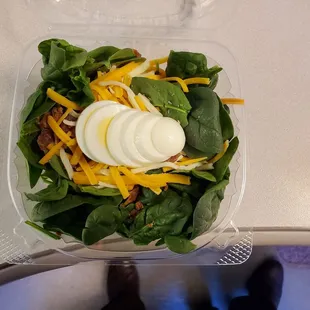 Spinach Salad in take-out clam shell container