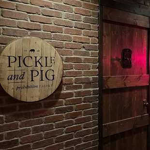 a neon sign on a brick wall