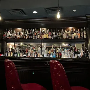 two red chairs at a bar