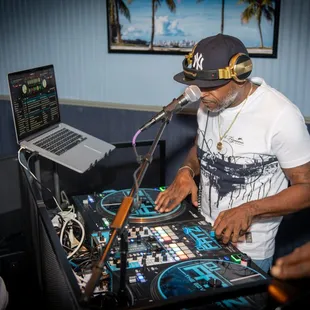 a dj in front of a laptop