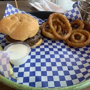 Burger with onion rings and pickle. Good.