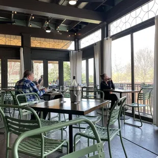 people sitting at tables in a restaurant