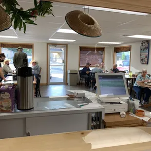 people sitting at tables in a restaurant